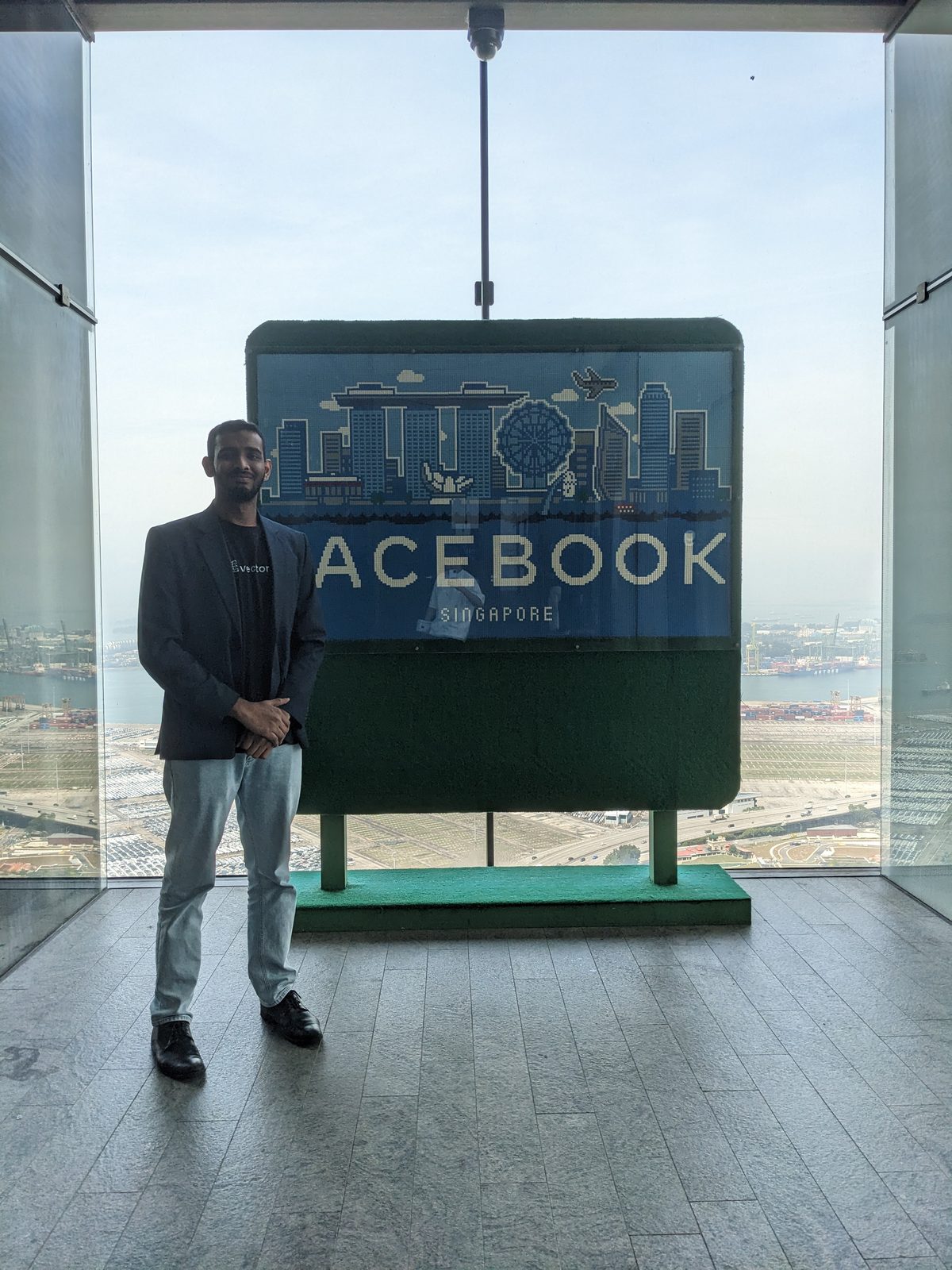 Ammar Ahamed at the Facebook Singapore sign inside Meta's Singapore office