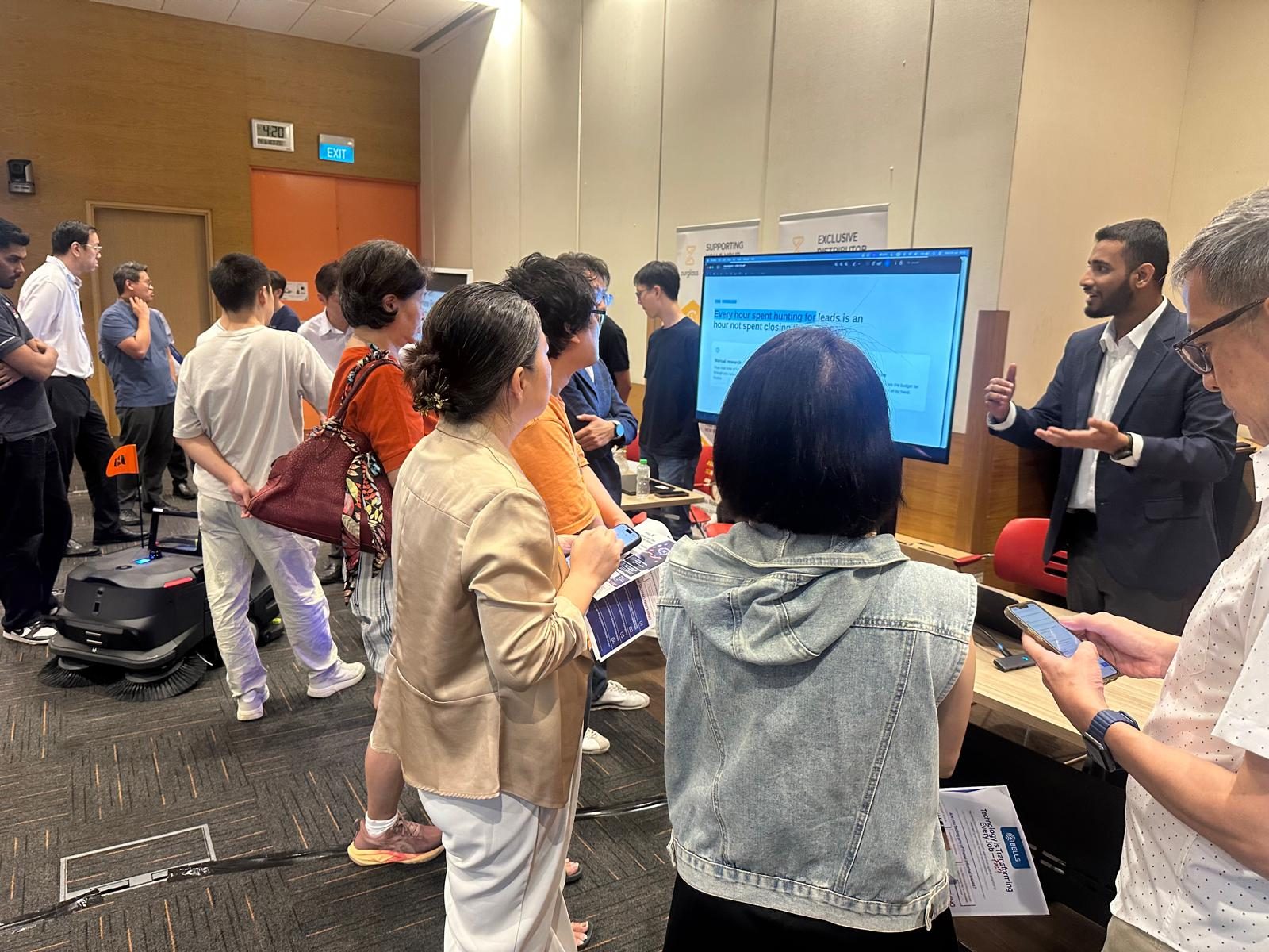 Demonstrating AI agents to business owners at the Singapore AI Association's AI Clinic, where Ammar Ahamed represented Vector Agents