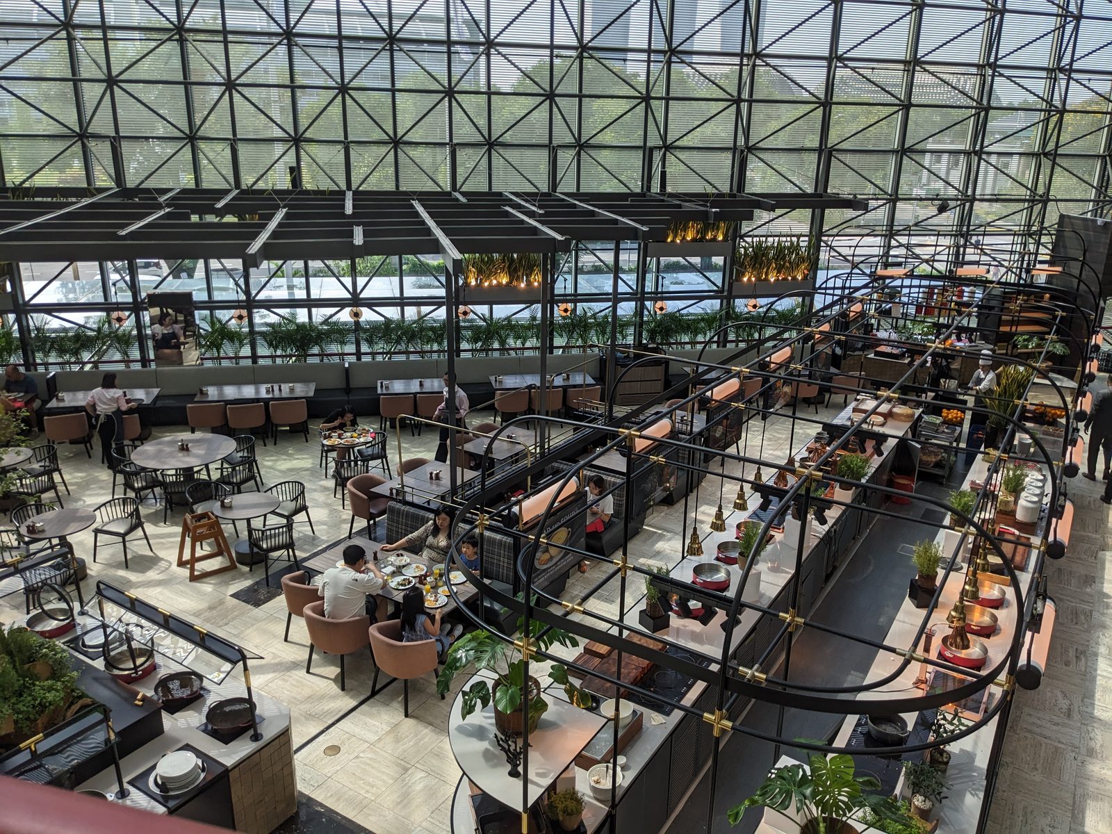 A glass-roofed coworking atrium in Singapore, on Ammar Ahamed's April 2026 trip