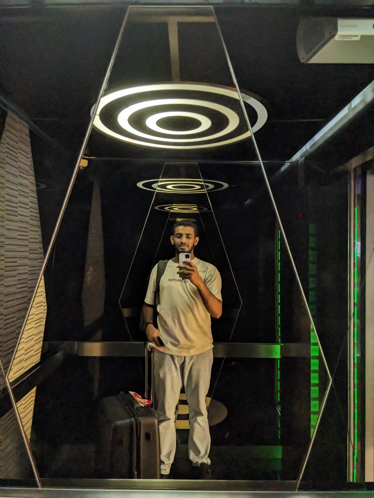 Ammar Ahamed inside a mirrored light installation in Singapore